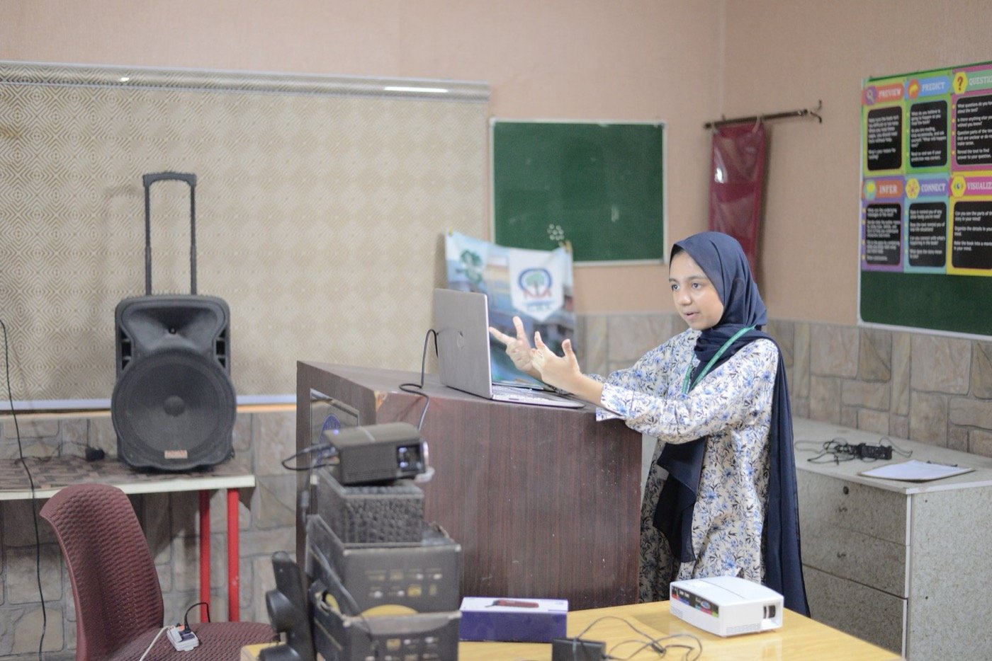A student presenting at the front of a classroom during a Portion and Comprehend session