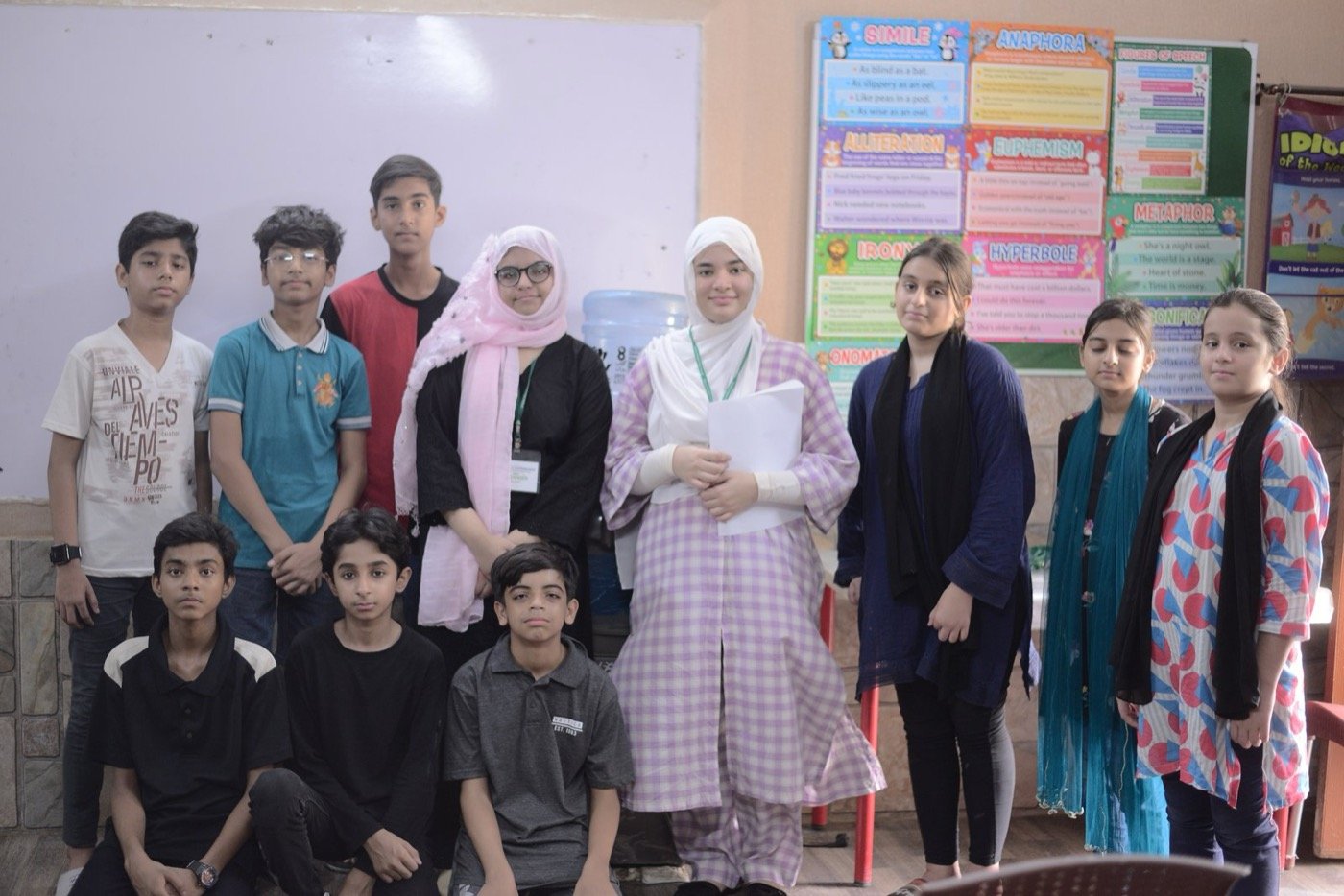 Portion and Comprehend students and mentors in a group photo in a classroom